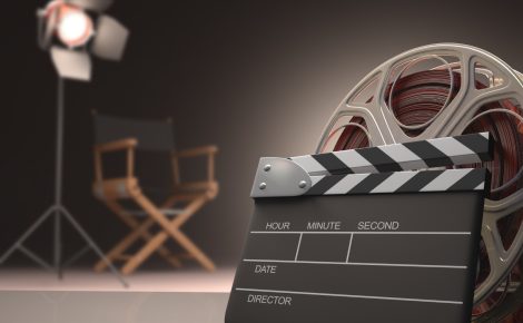 Claquete e rolo de filme em estúdio simbolizam o setor audiovisual brasileiro.