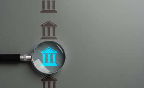 bank research. magnifying glass and a bank. interest rates, investment opportunities, and regulatory changes. valuable insights into financial products and services. promoting financial literacy