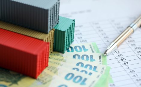company shipping cargo containers in european union with euro money bills and pen