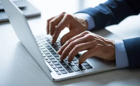 depositphotos 150403574 stock photo businessman working with laptop (1)